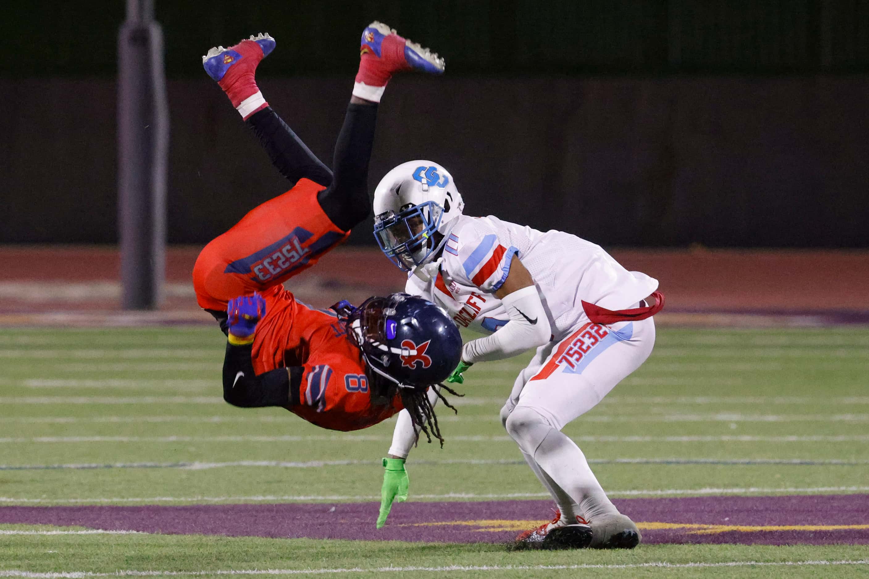 Kimball high’s Xavier Hampton (left) flips after getting charged by Carter high’s Charles...