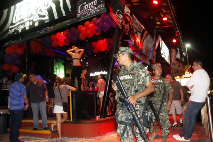 Mexican marines patrol the nightclub section of Cancún. “The perception that violence is...