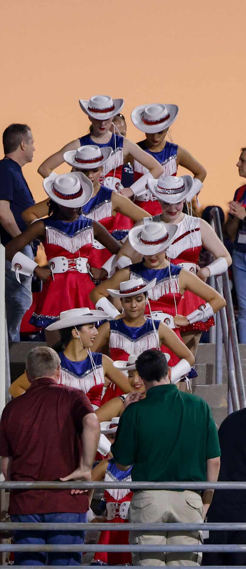 The Denton Ryan Strutters head down to practice before halftime as the sun sets over a...