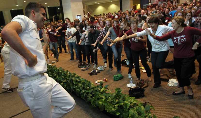 Senior Yell Leader Drew Nelson from Bryan tyeaches the crowd a new "Heisman" cheer as they...