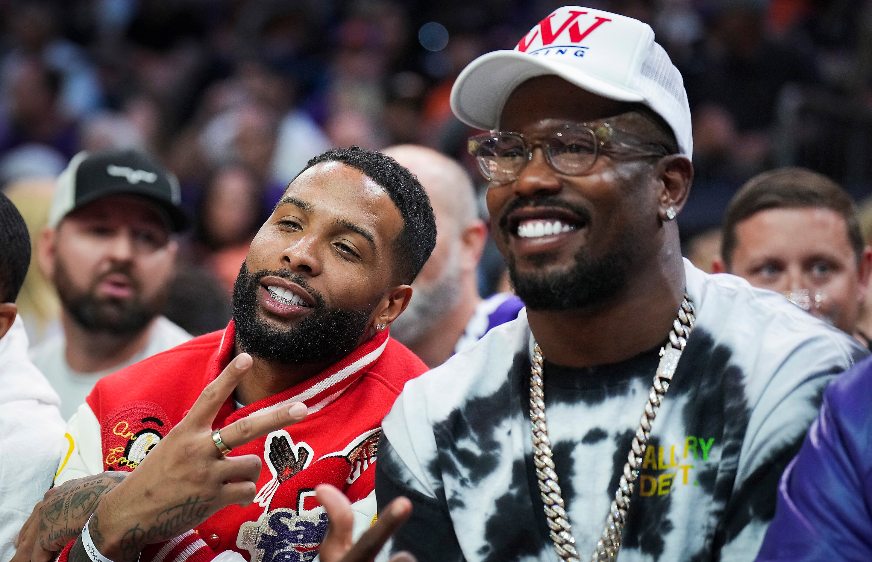 NFL players Von Miller (right) and Odell Beckham Jr. pose for a photo courtside during the...