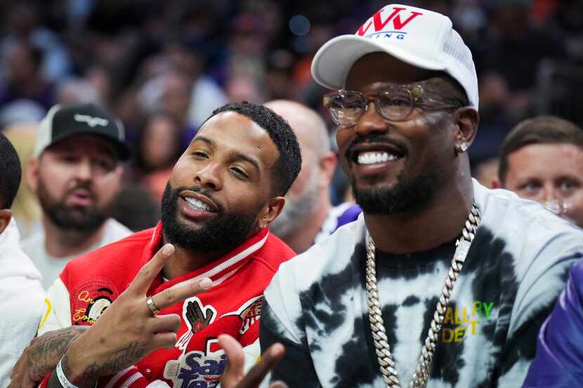 NFL players Von Miller (right) and Odell Beckham Jr. pose for a photo courtside during the...