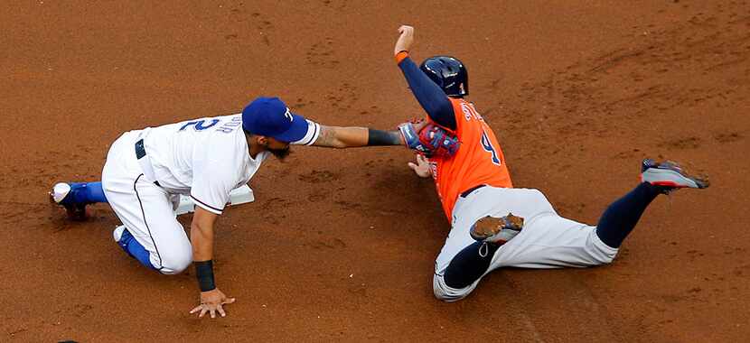  Texas Rangers second baseman Rougned Odor (12) tags out Houston Astros George Springer (4)...