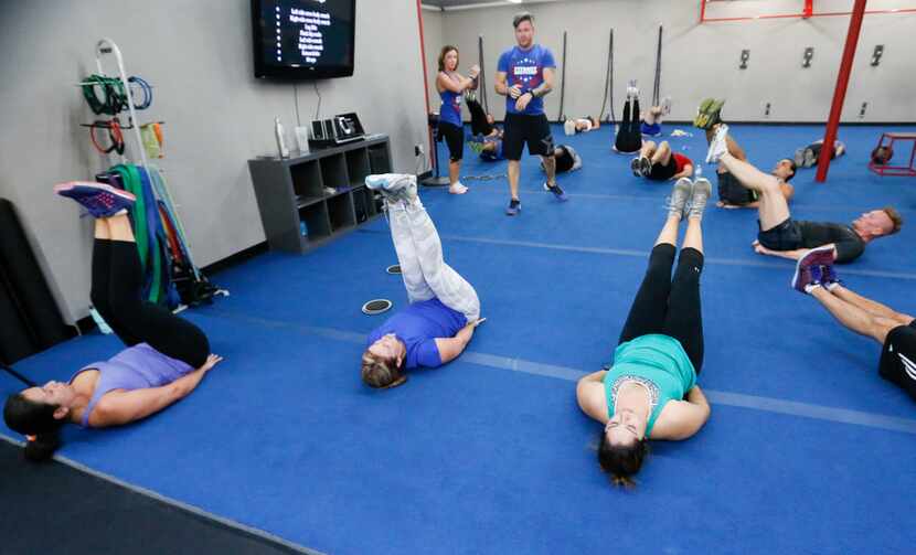 Stephanie Paur (standing left) and Turner Cavender (standing right) take boot camp...