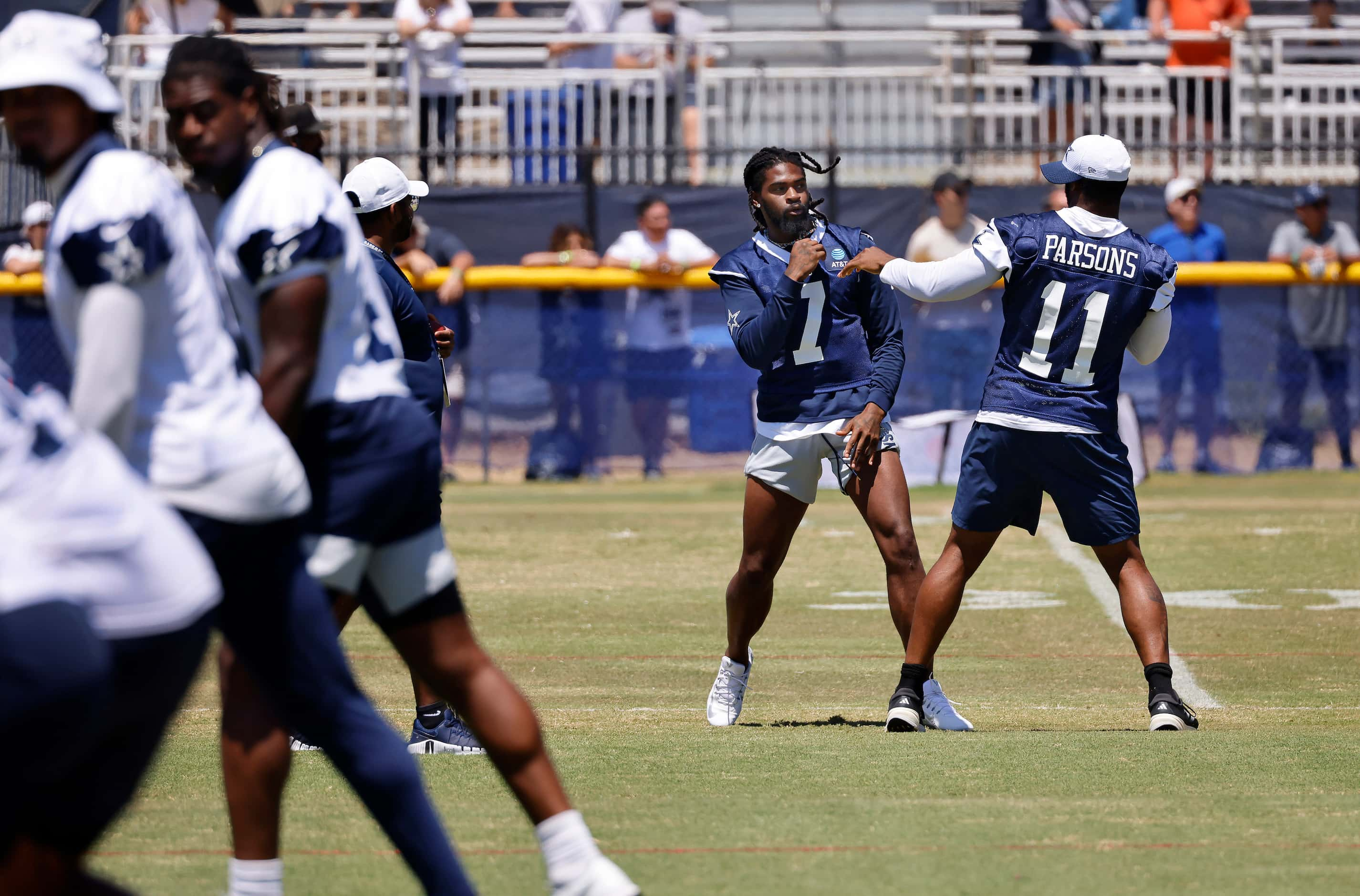 Dallas Cowboys cornerback Trevon Diggs (7) and linebacker Micah Parsons (11) playfully spar...