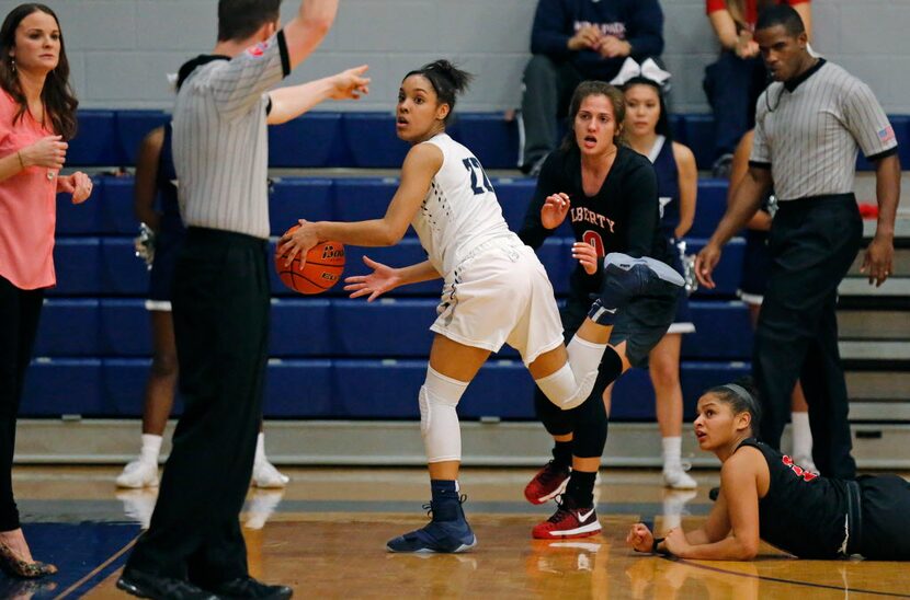 Lone Star guard Mia Deck (22) looks back at the ref to sort out the call along with everyone...