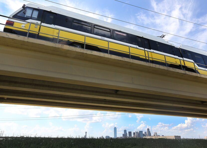 A DART train heads across the Trinity River basin towards the Eighth Street station, as the...