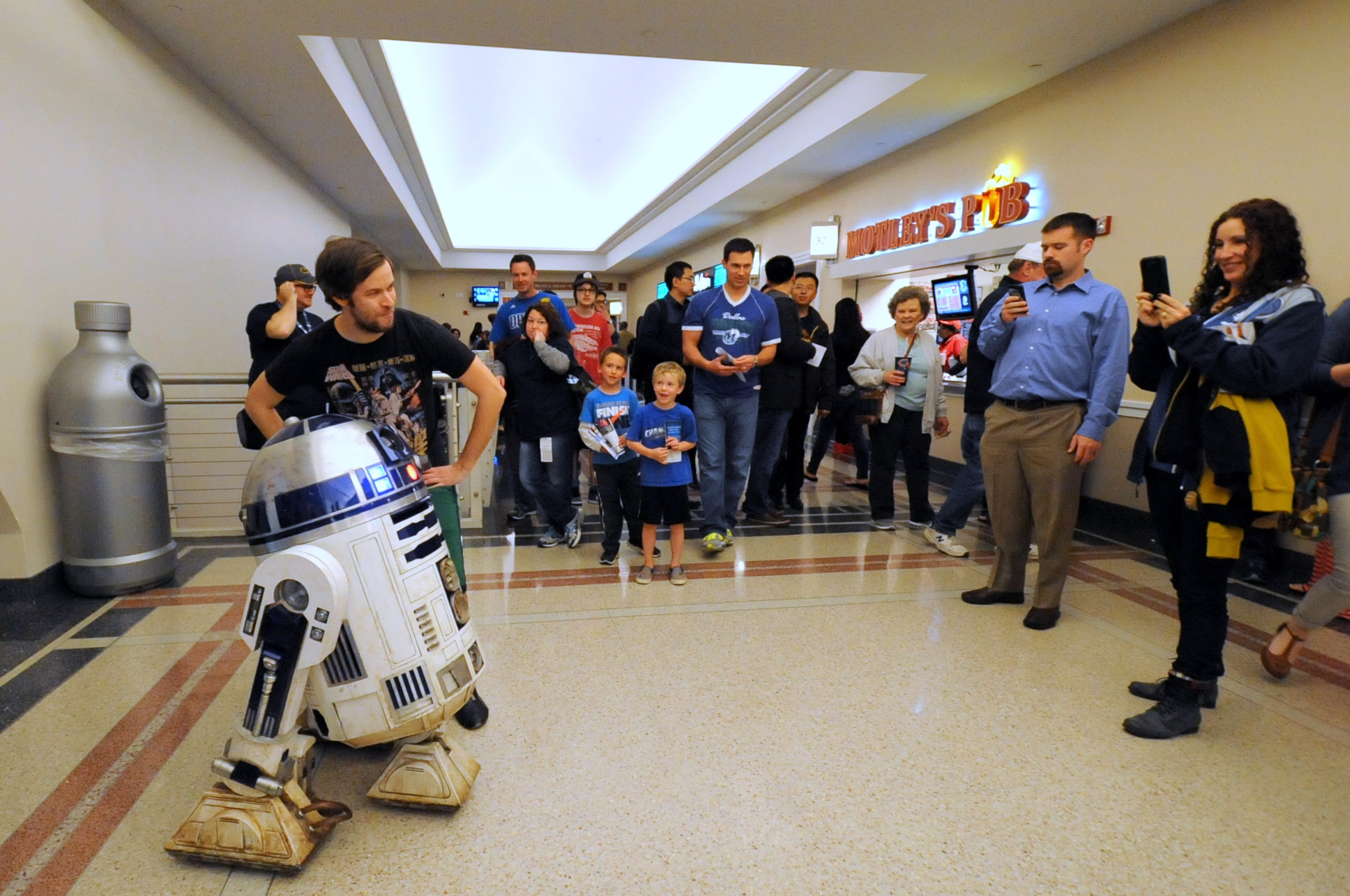 Fans meet R2-D2 at Star Wars night at the Dallas Mavericks basketball game at American...