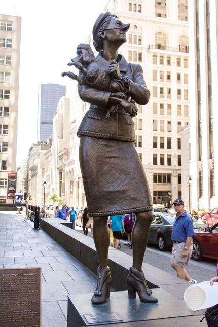 A statue of a French-Canadian woman turns up her nose at a neighboring English bank....