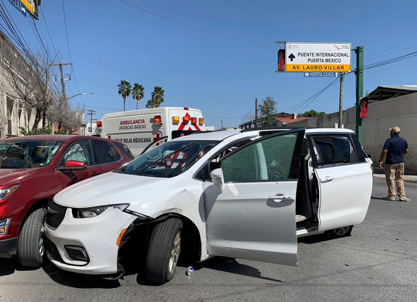 A member of a Mexican security force stands near the white minivan with license plates from...