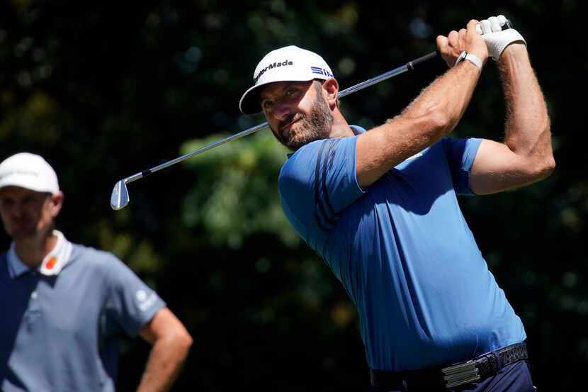 PGA Tour golfer Dustin Johnson watches his tee shot on No. 9 during the opening round of the...