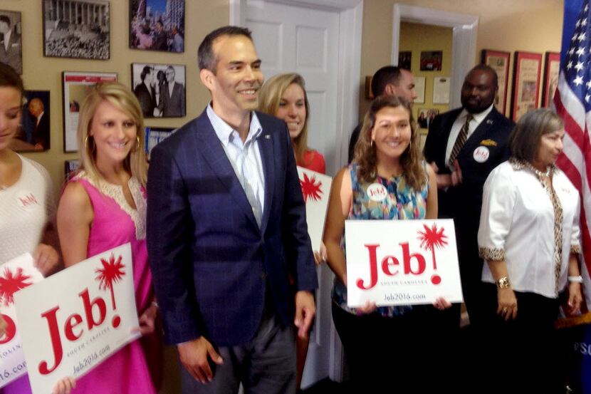 Texas Land Commissioner George P. Bush, third from the left, poses with supporters after...