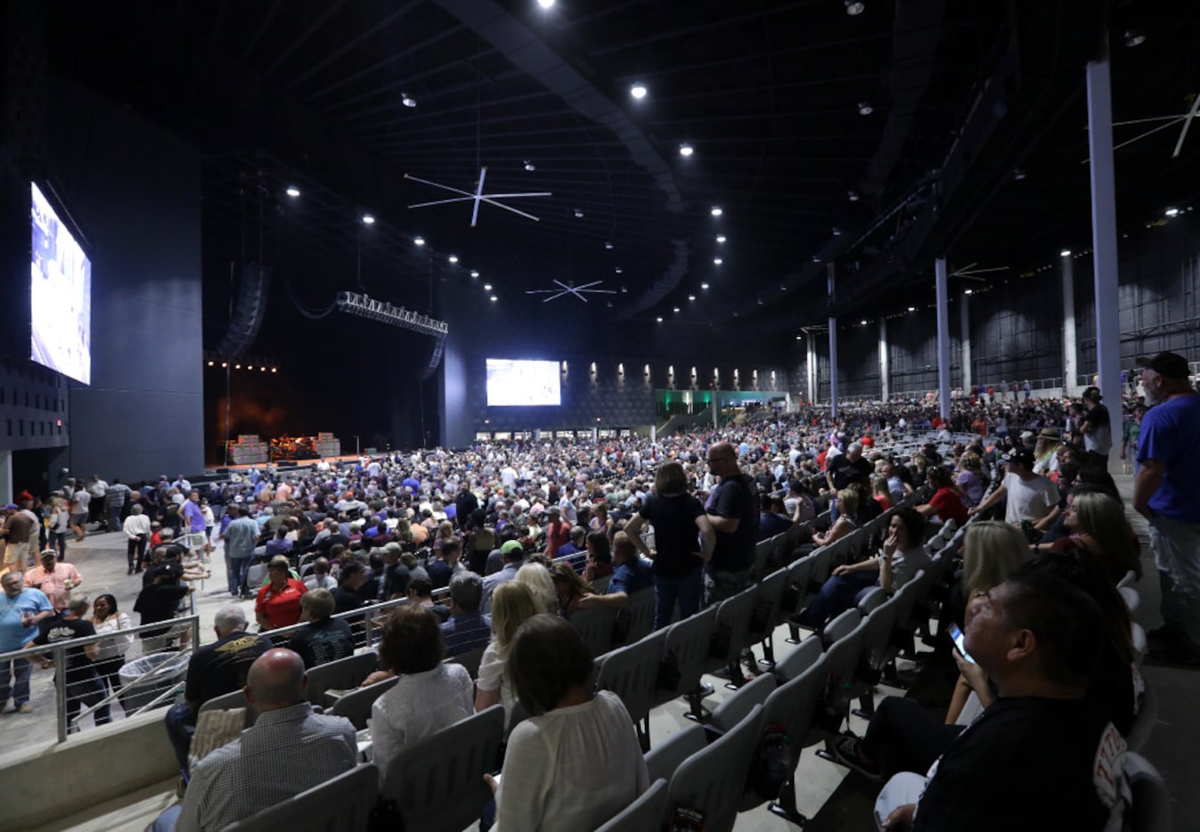 Fans look for their seats as they wait for ZZ Top to perform Saturday at Toyota Music...