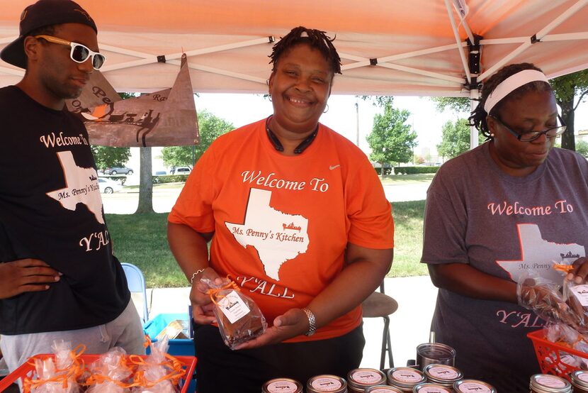 Ms. Penny Curry (center) gets a little help with Ms. Penny's Kitchen from sister June Forbes...