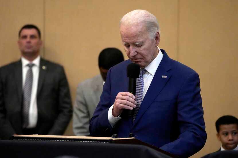 President Joe Biden bows his head in a moment of silence for the three American troops...