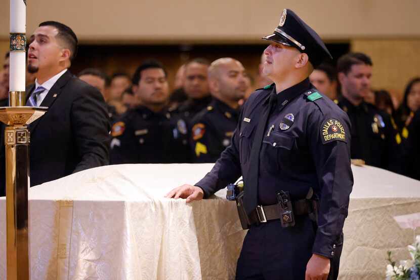 Dallas Police Officer Joshua Arellano (right) is overcome with emotion as he and his brother...