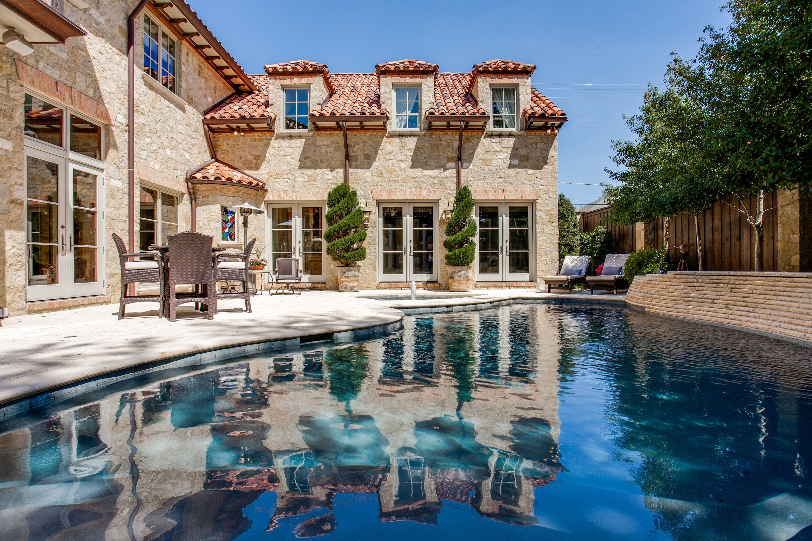 The home's master bedroom has a fireplace and private patio with staircase to the pool. 