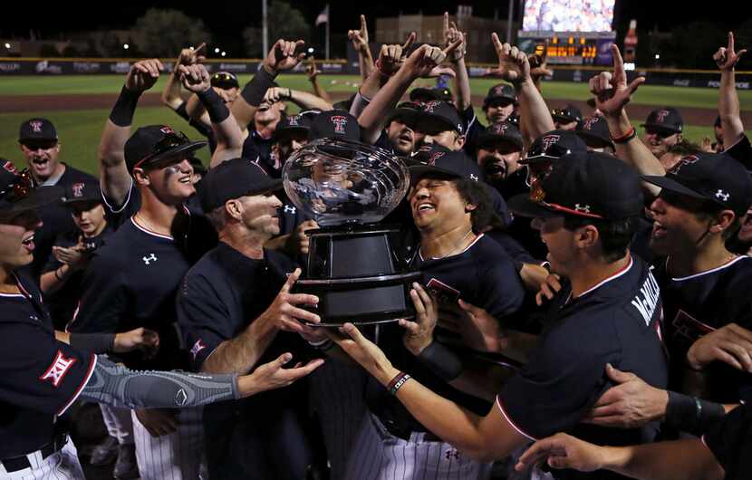 Texas Tech coach Tim Tadlock and Cameron Warren (11) hoist the Big 12 Conference...