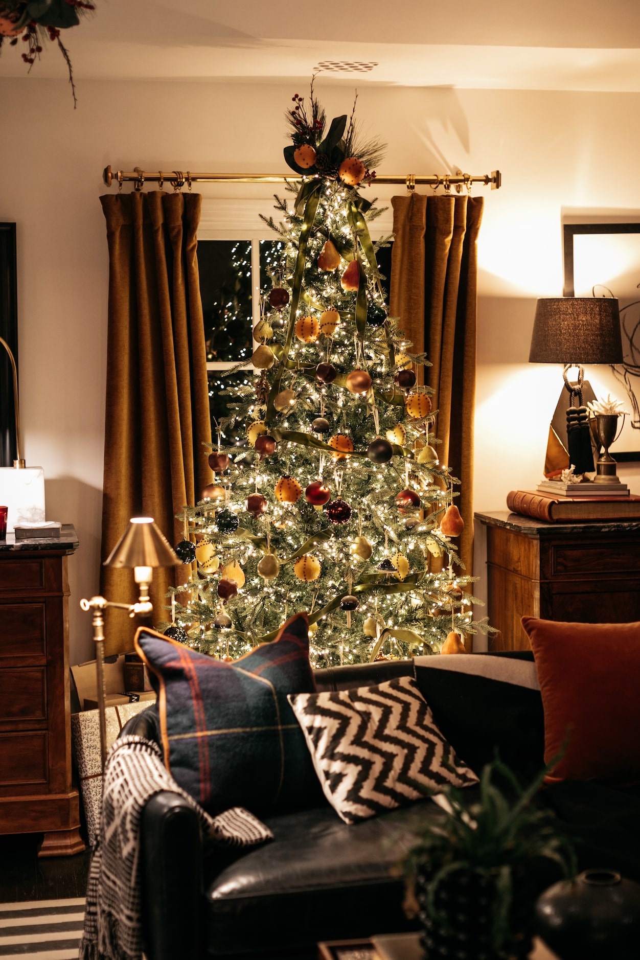 Burkle decorates the tree in the living room with a color palette that echoes the room's...