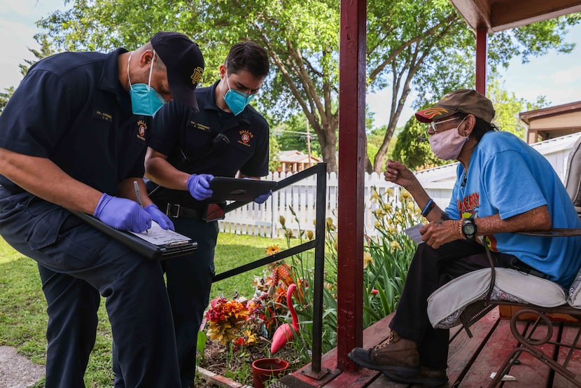 Dallas Fire-Rescue medic Corey Nix and driver engineer Robert Kober fill out paperwork from...