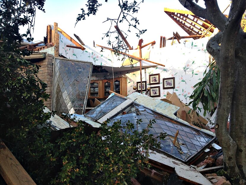 A collapsed home on Dorset Place, where photos still hung on the only remaining wall.