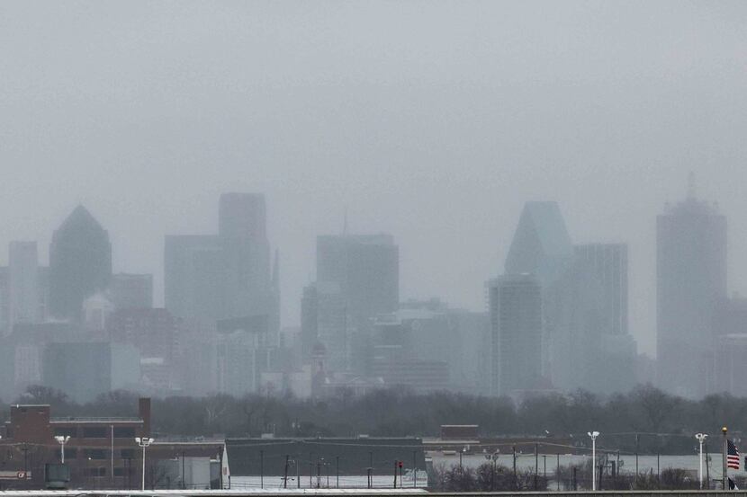 The Dallas skyline less visible from the Dallas Love Field airport as a wave of ice/sleet...
