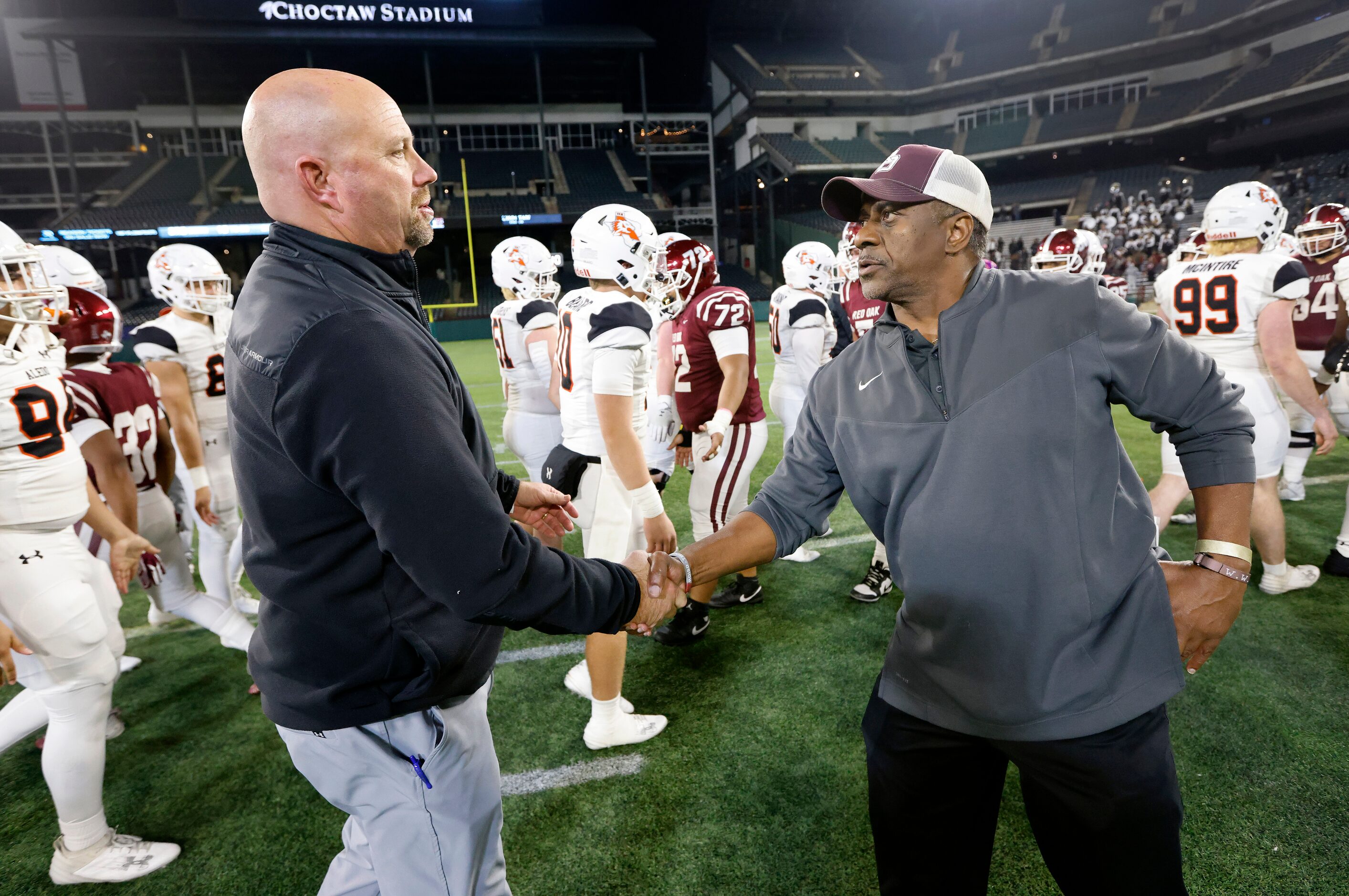 Aledo head coach Robby Jones (left) and Red Oak head coach Melvin Robinson shake hands...