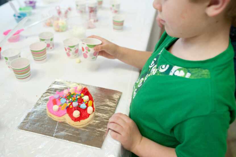 Beau Thompson, 6, decorated cookies at NorthPark Mall in a fundraising event for Paint the...