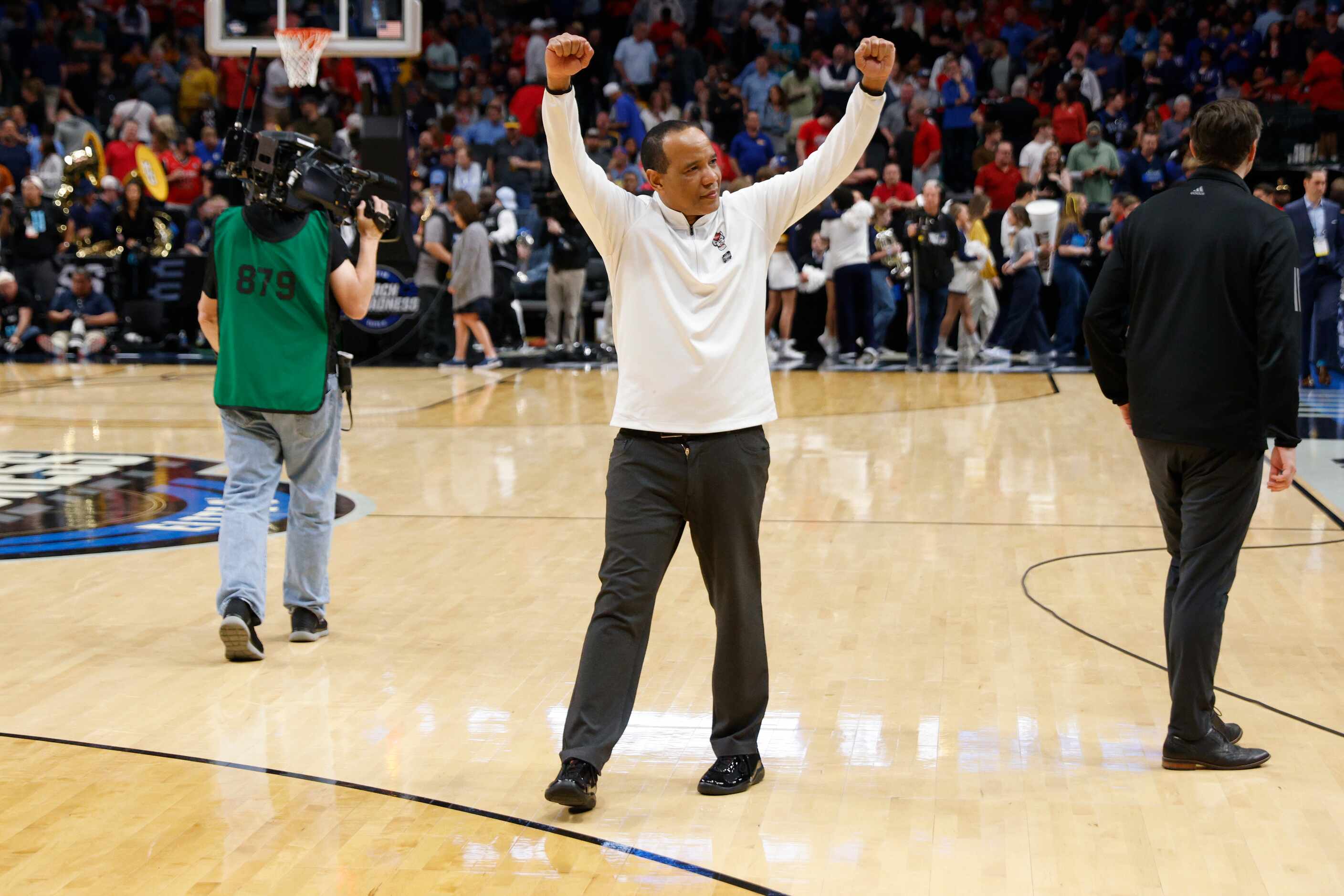North Carolina State head coach Kevin Keatts raises his arms after winning an NCAA Men’s...