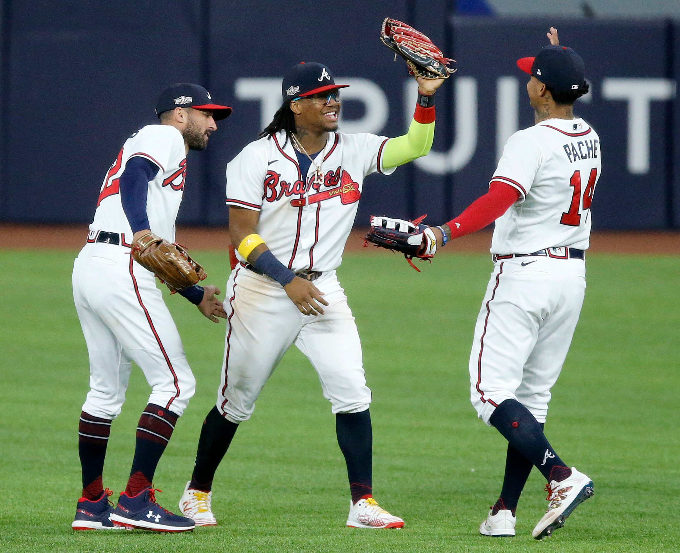 Atlanta Braves outfielders Nick Markakis (22), Ronald Acuna Jr. (13) and Cristian Pache (14)...