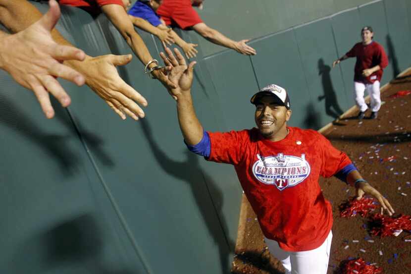 Texas Rangers Nelson Cruz (17) greets fans in the outfield to celebrate a victory over the...