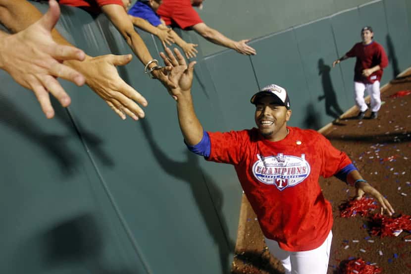 Texas Rangers Nelson Cruz (17) greets fans in the outfield to celebrate a victory over the...