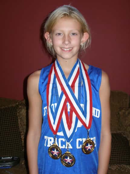 Lauren Cox at age 8 poses with medals after winning the 50m dash, 100m dash and high jump at...