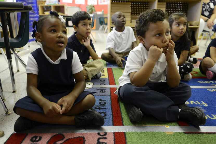 Prekindergartners Za'naae Alley and Edwin Avalos listened to a lesson at Kramer Elementary...
