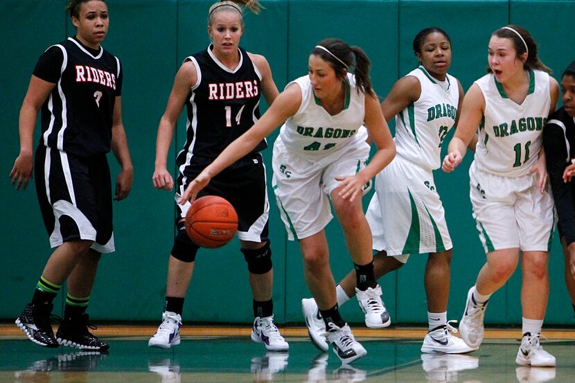 Southlake Carroll's Kayla Reinhart (42) takes control of the ball as her teammates and THESA...