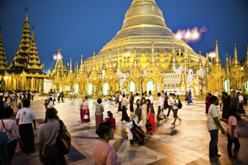 Sunset gathering at the ancient Shwedagon Pagoda, which have been a key meeting place in...