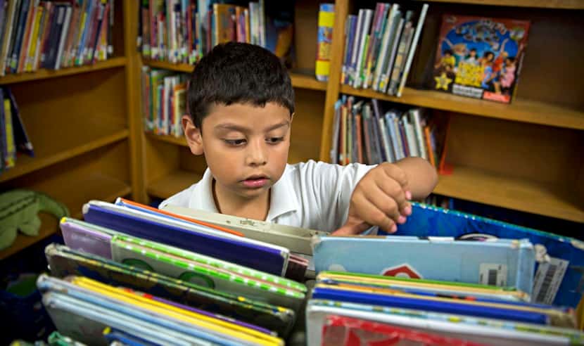 
First-grader Marcelo Favela, 6, peruses books at Macon Elementary’s library. Students at...