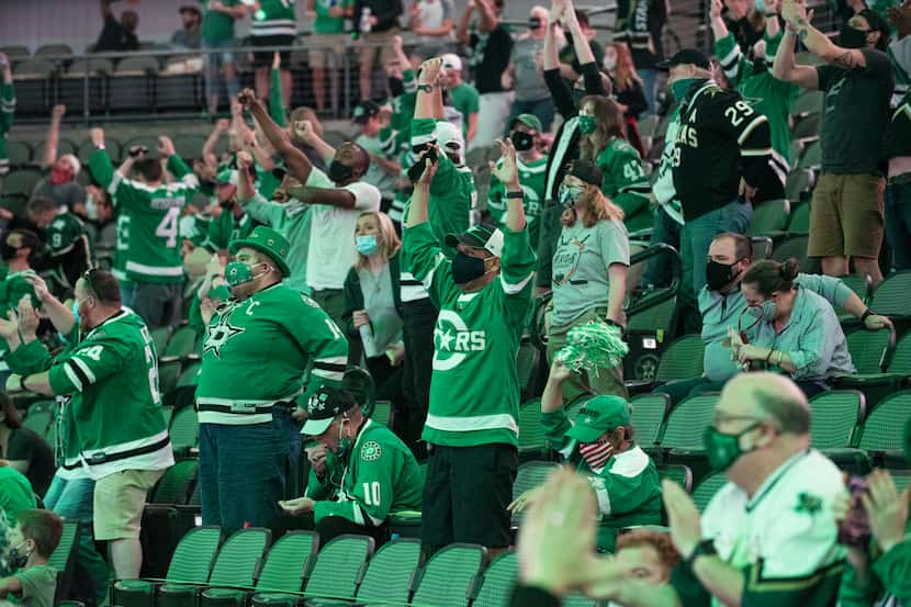 Stars fans react as the Dallas Stars scored a goal in the third period versus the Tampa Bay...