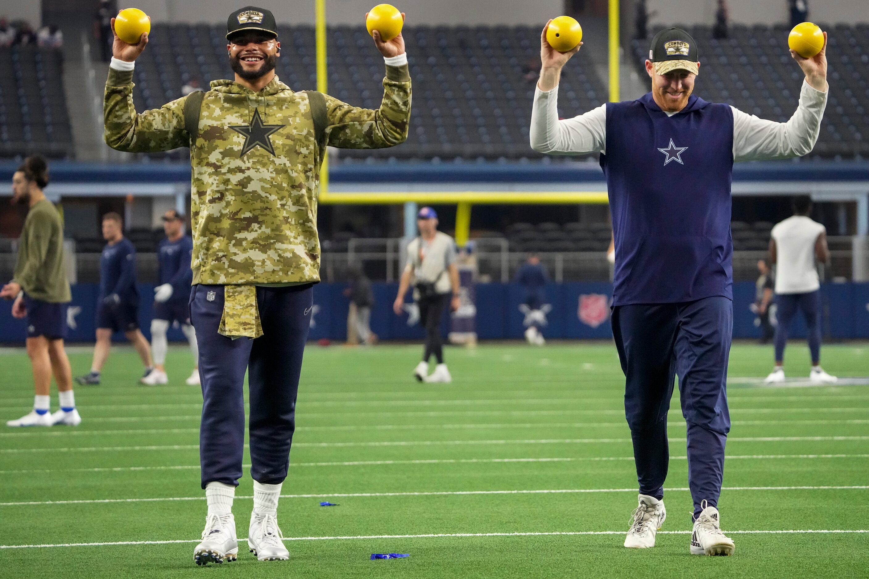 Dallas Cowboys quarterback Dak Prescott (left) and quarterback Cooper Rush stretch before an...