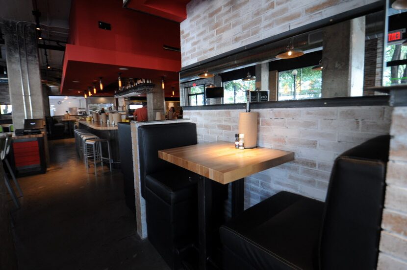 Booths line the brick walls at Hopdoddy Burger Bar on McKinney Avenue. The restaurant opens...