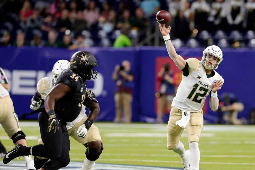 Baylor quarterback Charlie Brewer (12) passes the ball as Vanderbilt defensive lineman Dare...