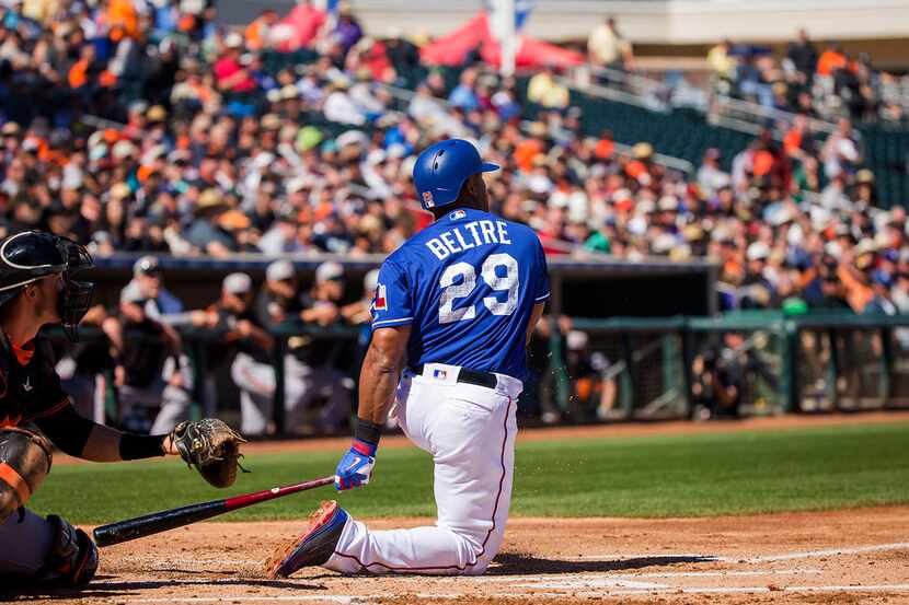 Texas Rangers third baseman Adrian Beltre drops to one knee after hitting a single in his...