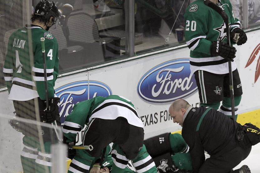 Dallas Stars defenseman Stephane Robidas (3) lies on the ice after being hurt in the second...