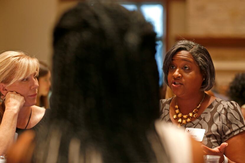 Rachel Ridge (left) listens to Rep. Rhetta Bowers, D-Dallas, at a dining table during the...