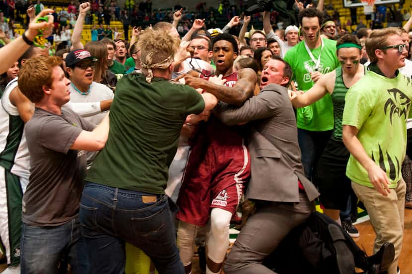 In this Thursday, Feb. 27, 2014 photo, New Mexico State's Daniel Mullings, at center in red...