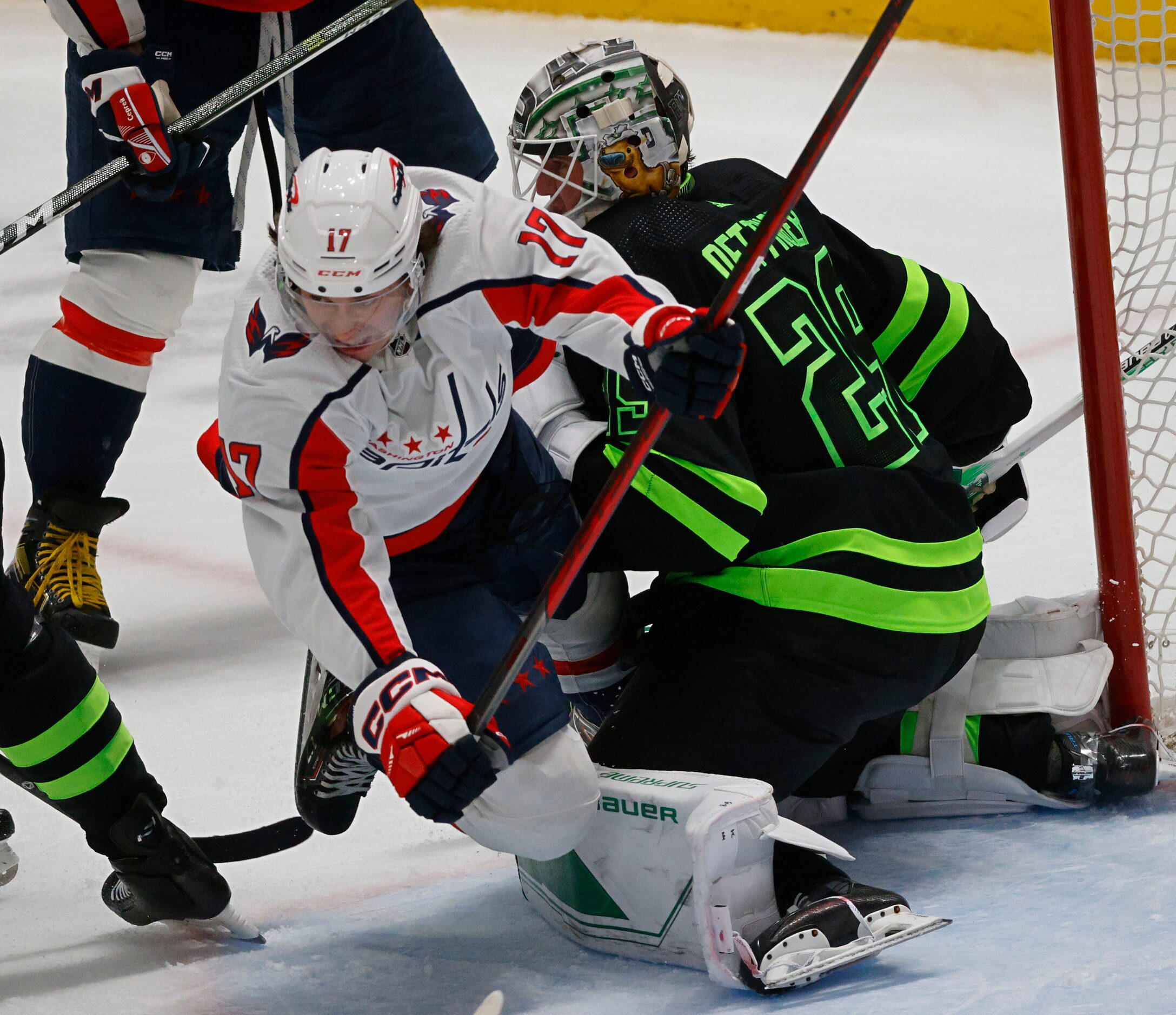 Washington Capitals center Dylan Strome (17) tangles with Dallas Stars goaltender Jake...