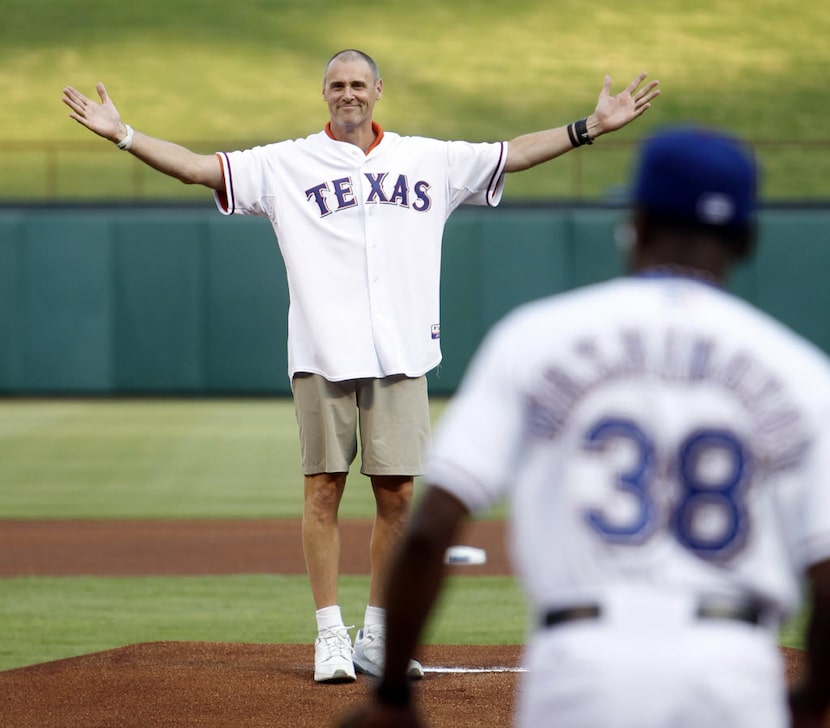 Dallas Mavericks head coach Rick Carlisle gestures after throwing the first pitch to Texas...