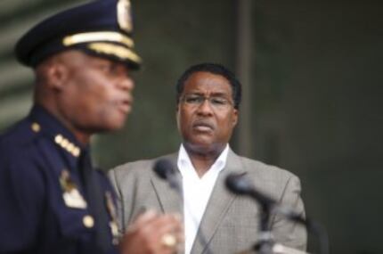  Mayor Dwaine Caraway (right) listens to Dallas Police Chief, David Brown, as he emphasizes...