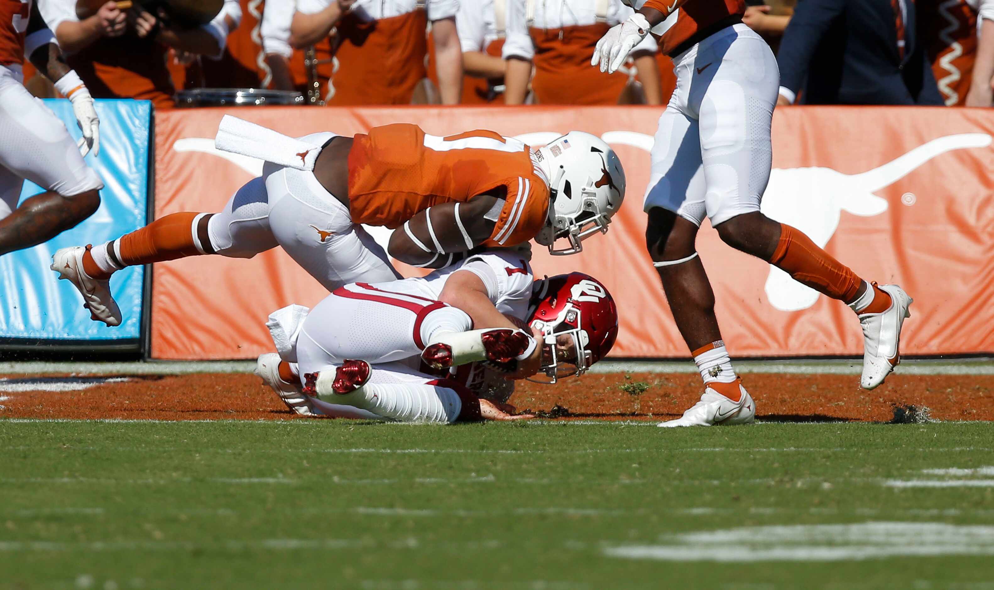 Oklahoma quarterback Spencer Rattler (7) scores a touchdown as Texas linebacker DeMarvion...