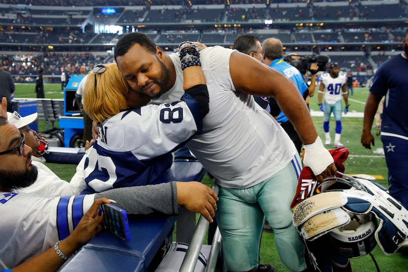 Dallas Cowboys defensive end Jeremy Mincey (92) receives a hug from super fan Carolyn Price...